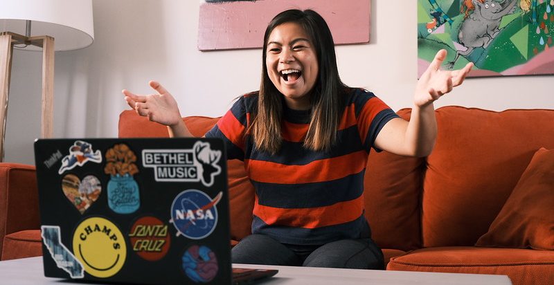 woman smiling at laptop