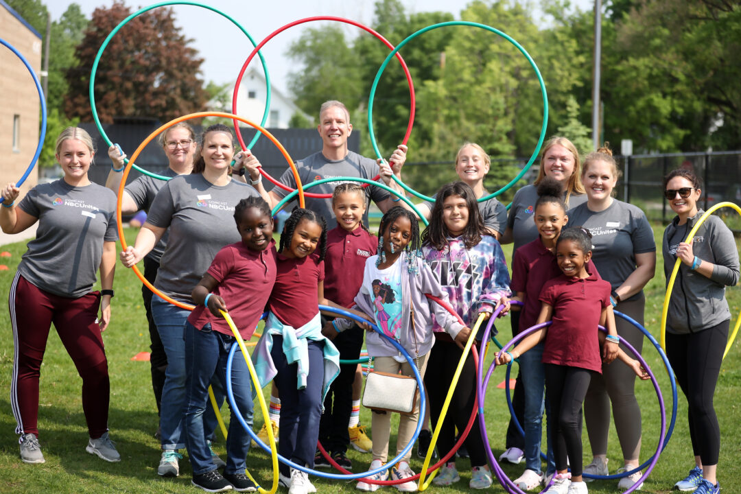 kids and adults posing with hula hoops