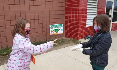 two girls playing rock paper scissors